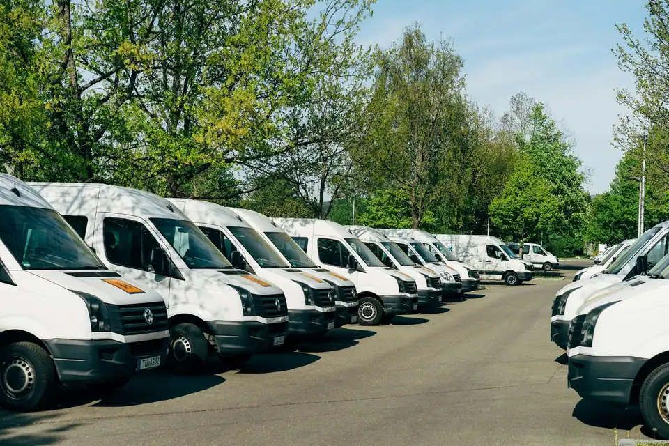 A row of white service vans ready for the day