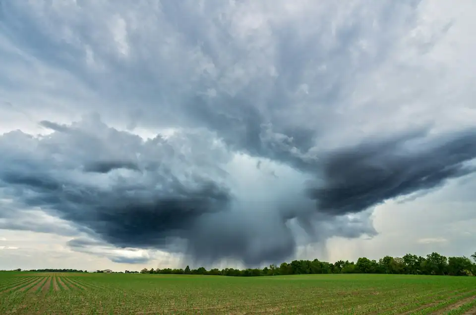A storm building over rooftops