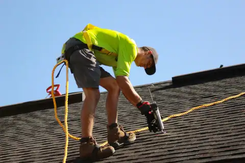 A Ridgeline roofer sealing a shingle roof